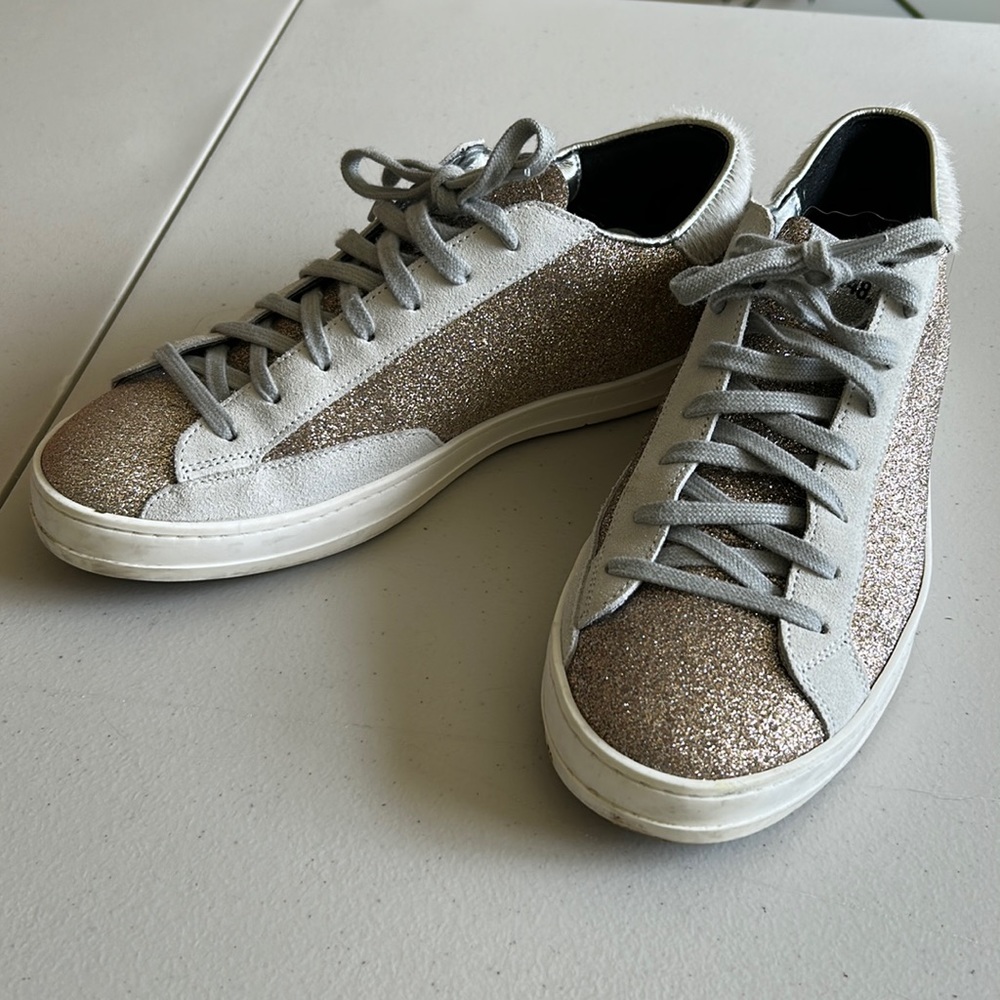 P448 tennis shoe in size 39 (8.5), gold sparkle with leather details.